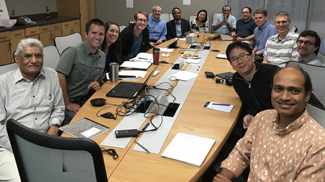 The faculty participating in the NRT seated around a table in a meeting